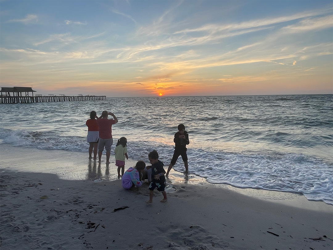 A family plays at a Naples beach