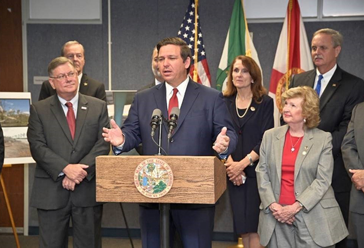 Penny Taylor listening to Governor Ron DeSantis